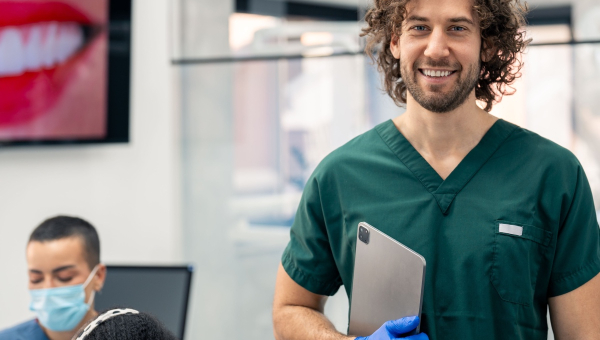 A smiling dentist with the OrthoPhoto app